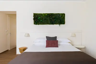 a bedroom with a white bed with a red pillow at Borghetto Guest House in Rome