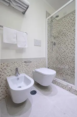 a bathroom with a toilet and a sink and a shower at Lory House in Rome