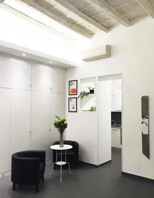 a room with a table and chairs and a vase of flowers at Casa Brunetti in Rome
