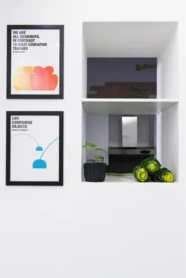 three pictures on a white wall with fruit on a shelf at Casa Brunetti in Rome