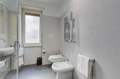 a white bathroom with a toilet and a sink at AV Domus Vatican St.Peter B&B in Rome