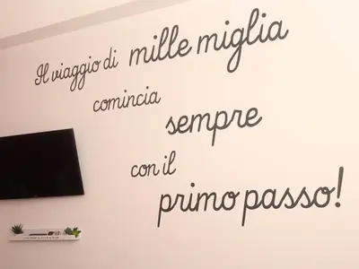 a wall with a tv and some writing on it at Dormi a Roma in Rome