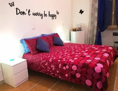 a bedroom with a red bed with a red comforter at B&B Stelle Di Roma in Rome