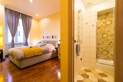 a bedroom with a bed and a shower at B&B Arco Di Gallieno in Rome