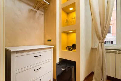a bathroom with a white dresser and a shower at B&B Arco Di Gallieno in Rome