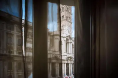 a window view of a building with a clock tower at Glam Sm Maggiore Guest House in Rome