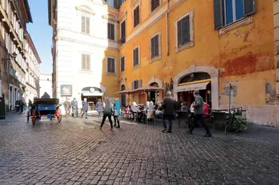 a group of people walking down a street in a city at Pantheon Family Romantic Suite in Rome