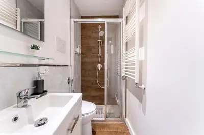a bathroom with a toilet and a sink and a shower at About Colosseo - Appartamento al Colosseo nel cuore di Roma - Free WiFi in Rome