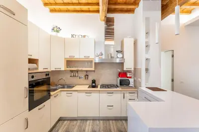a kitchen with white cabinets and white appliances at About Colosseo - Appartamento al Colosseo nel cuore di Roma - Free WiFi in Rome