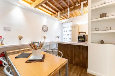 a kitchen and dining room with a wooden table at About Colosseo - Appartamento al Colosseo nel cuore di Roma - Free WiFi in Rome