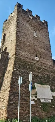 a large brick building with two parking meters in front of it at Retro Rooms Termini in Rome