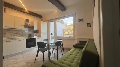 a living room with a couch and a table and chairs at Rome Apartment with terrace Autonomous in Rome