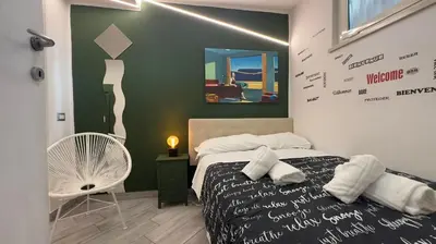 a bedroom with a bed and a chair in it at Rome Apartment with terrace Autonomous in Rome