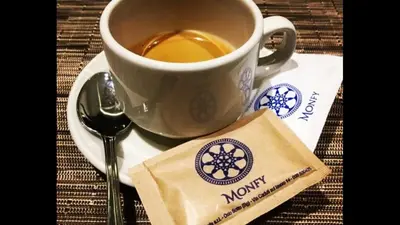 a cup of coffee on a plate with a spoon at Residenza Monfy in Rome