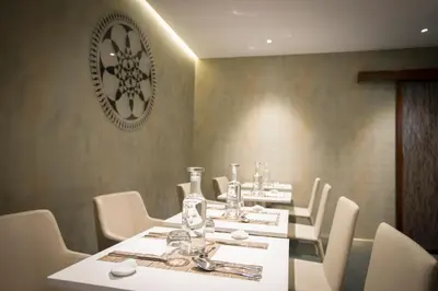 a dining room with white tables and white chairs at Residenza Monfy in Rome
