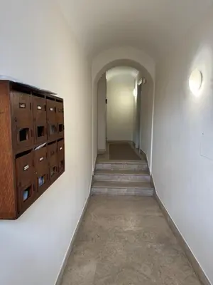 an empty hallway with wooden cabinets and a long corridor at Campo dei Fiori modern apartment with terrace in Rome