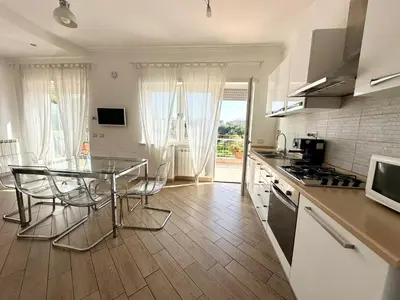 a kitchen with a glass table and a counter top at Terrazza sul Parco in Rome