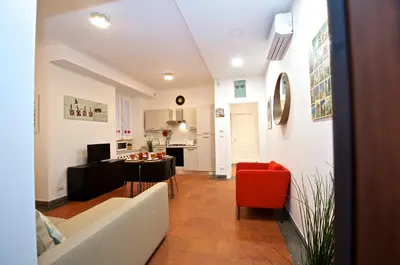 a living room with a couch and a red chair at Flaminio Butterfly House in Rome