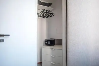 a room with a closet with a microwave on a shelf at Roma 2B in Rome