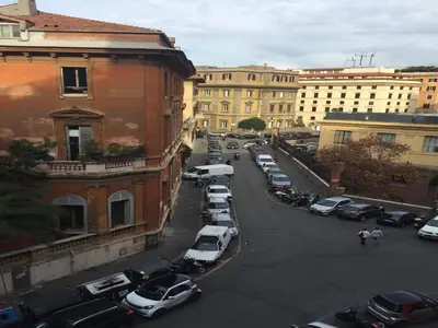 a city street with cars parked in a parking lot at Roma 2B in Rome