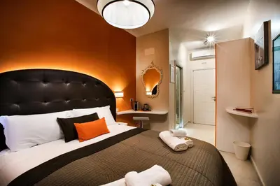 a bedroom with a large bed with a black headboard at Guest House Grazioli in Rome