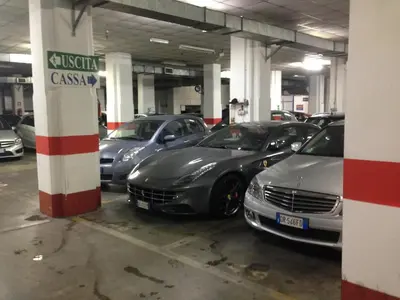 a group of cars parked in a parking lot at Fotofever Apt, two bedrooms with air conditioned in elegant shopping area, close to Vatican City in Rome