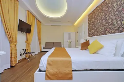 a hotel room with a bed and a tv at Alla Locanda Malandra in Rome