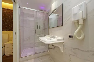 a bathroom with a shower and a sink at Alla Locanda Malandra in Rome
