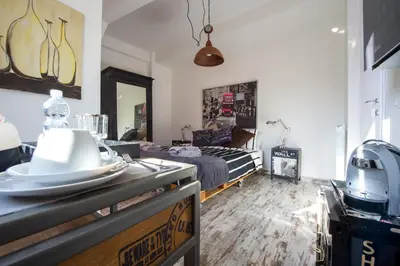 a room with a bed and a table with a hat on it at Letto e Latte Roma Guest House in Rome