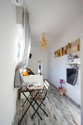 a living room with a table and a bed at Letto e Latte Roma Guest House in Rome