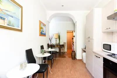 a kitchen and dining room with tables and chairs at Dreams Roma B&B in Rome