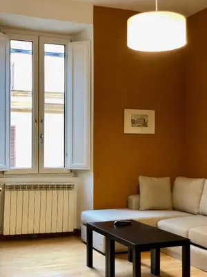 a living room with a couch and a table at Monti Friendly Rome House in Rome