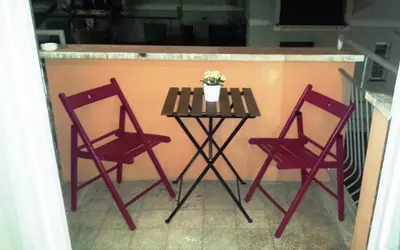a table with two chairs and a table with a potted plant at Romulea Guest House in Rome