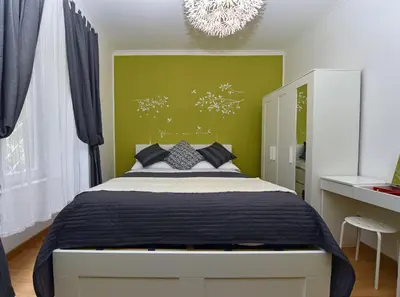 a bedroom with a bed and a green wall at Jubilee 2 in Rome