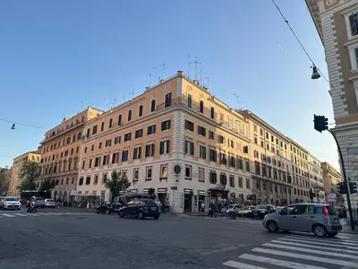 a large building on a busy city street with cars at Candia41 in Rome