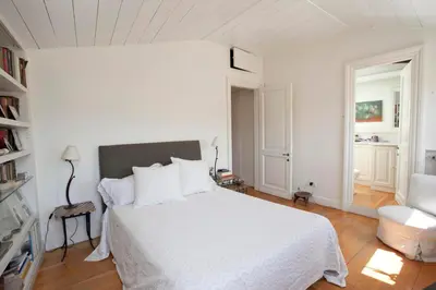 a white bedroom with a bed and a chair at Terrace Jewel by Campo de Fiori in Rome