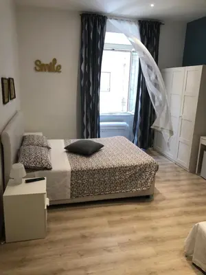 a bedroom with a bed and a window at Spazio Cavour Guesthouse in Rome