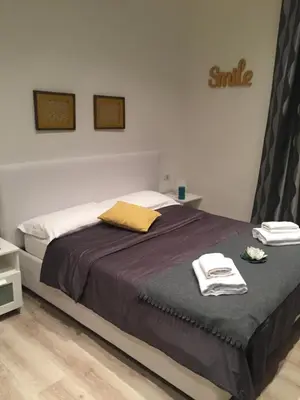 a bedroom with a bed with two towels on it at Spazio Cavour Guesthouse in Rome