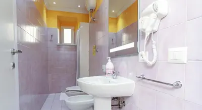 a bathroom with a sink and a toilet and a phone at Termini Suites in Rome