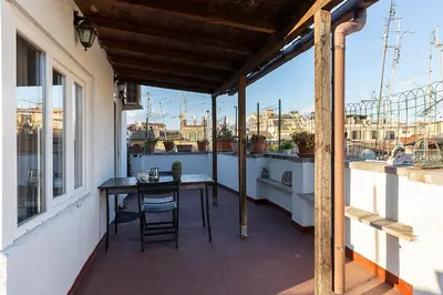 a patio with a table and chairs on a balcony at Tetti di Piazza Navona in Rome