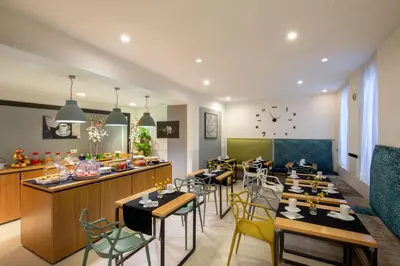a restaurant with tables and chairs and a counter at Viminale View Hotel in Rome