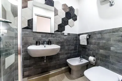 a bathroom with a sink and a toilet and a mirror at Mr. Charlie Brown in Rome