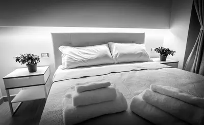 a bedroom with a bed with towels on it at Mr. Charlie Brown in Rome