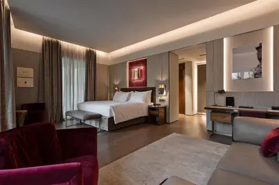 a hotel room with a bed and a couch at Fendi Private Suites - Small Luxury Hotels of the World in Rome