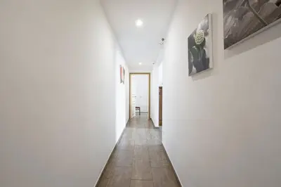 a hallway with white walls and a tile floor at Cuore di Testaccio Apartment in Rome