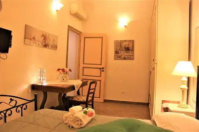 a small room with a table and a room with a bed at Cuore di Testaccio Apartment in Rome