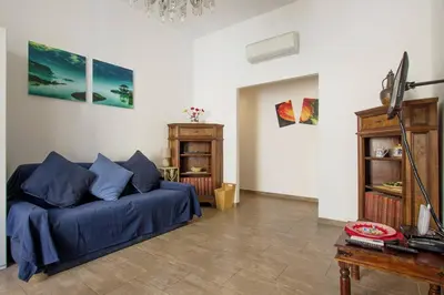 a living room with a blue couch and a table at Cuore di Testaccio Apartment in Rome