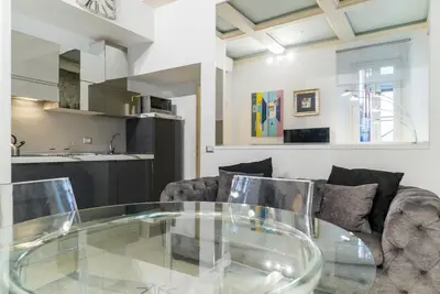 a glass table in a living room with a couch at Prinsi Apartments in Rome