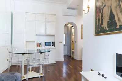 a kitchen with a glass table in a room at Prinsi Apartments in Rome