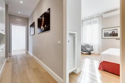 a bedroom with a bed and a wall with a tv at Vatican Guest House in Rome